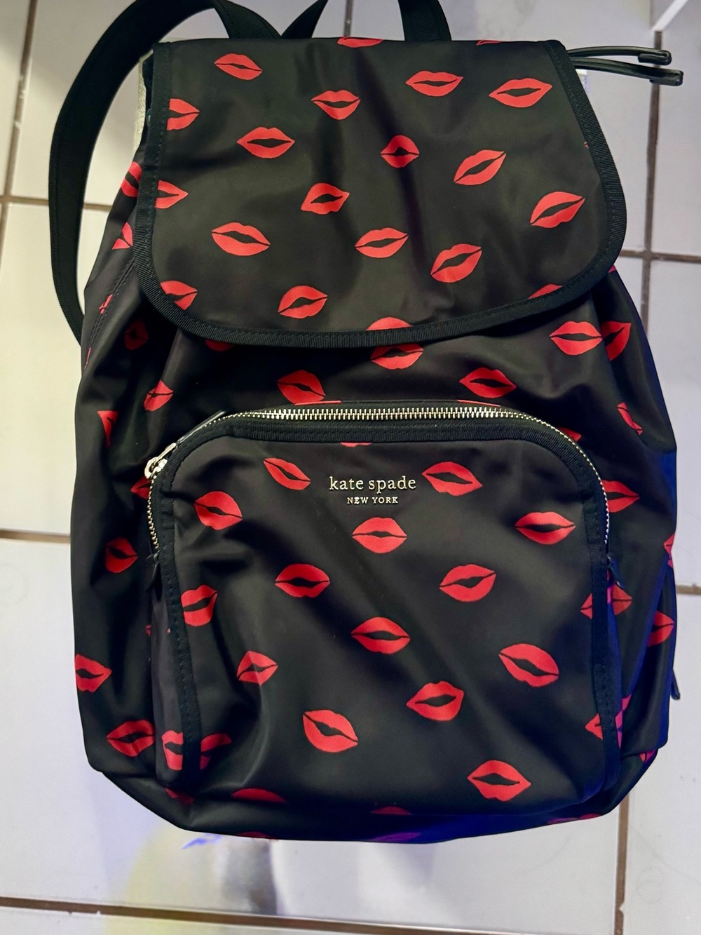 kate spade black backpack with red lip print